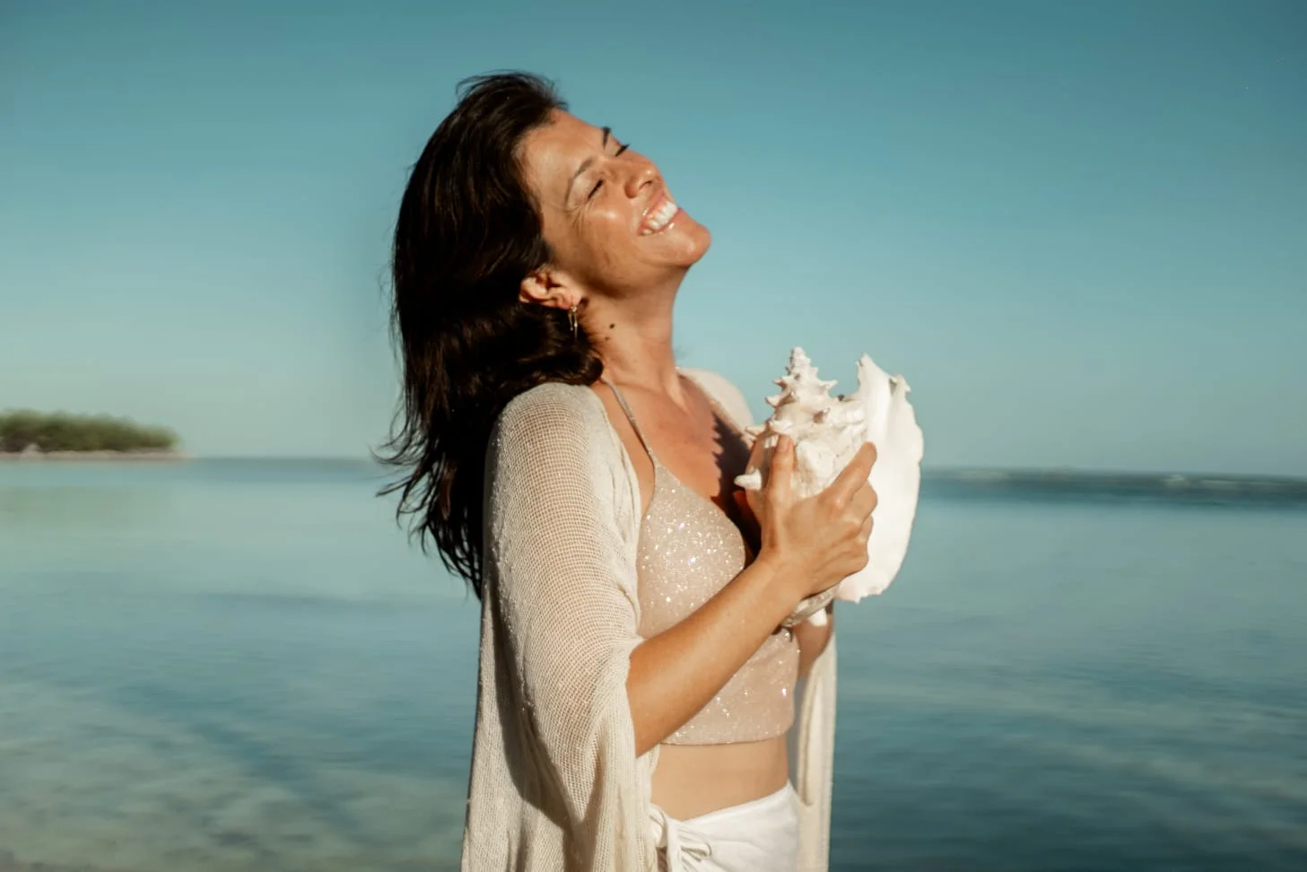 Ana Cristina smiling by the sea